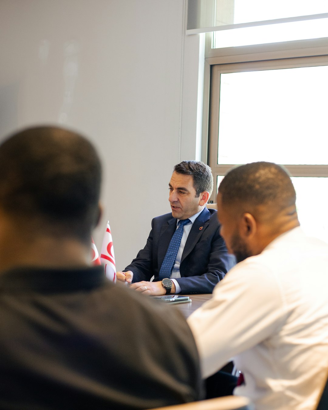 two-men-in-suits-meeting-with-two-other-men-om-hmwt0xz8